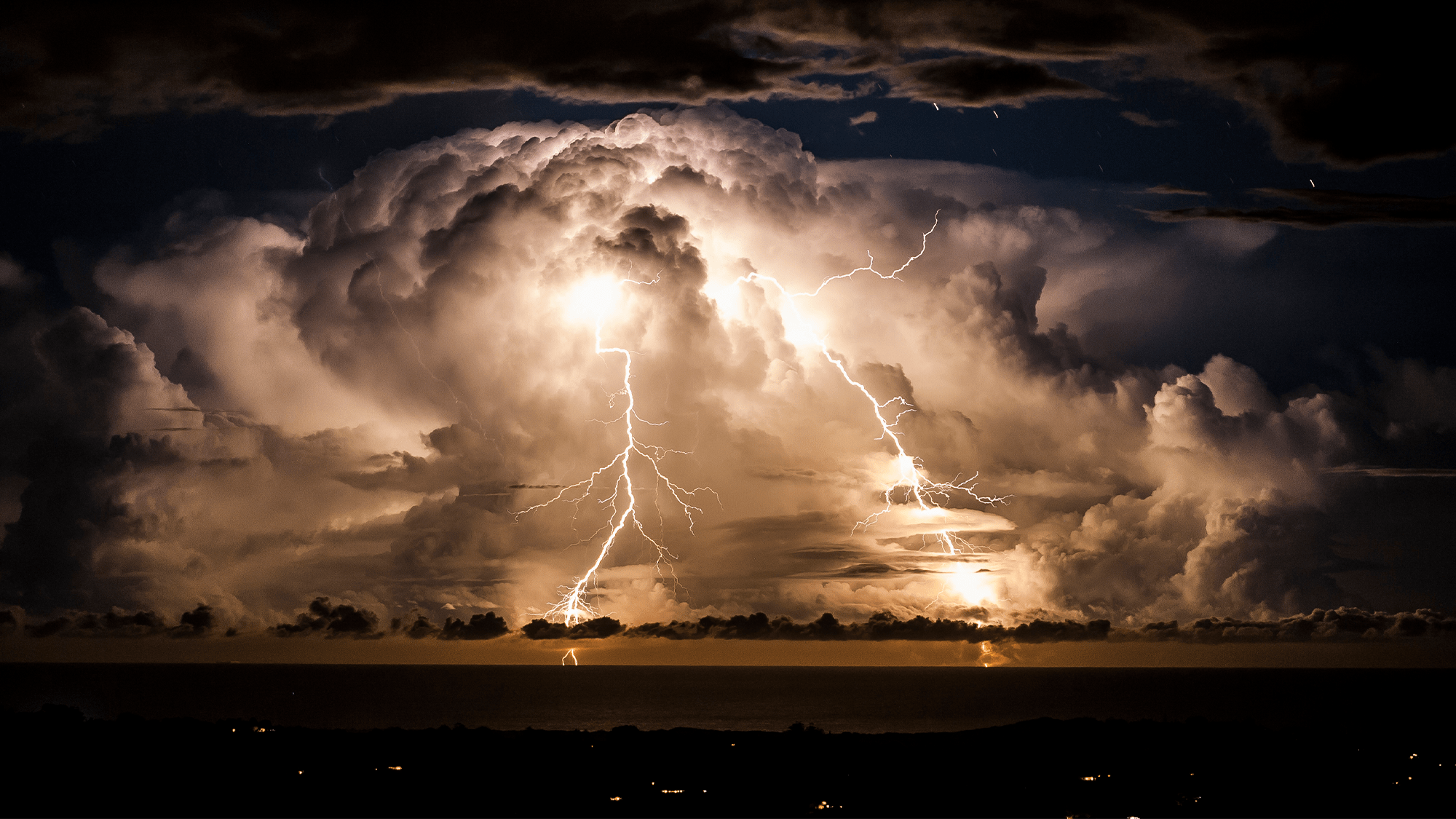 An electrical storm off the coast of Byron Bay, Australia. The changing sky dazzles with a natural light show of lightning bolts and billowing clouds dance in the sky for hours.